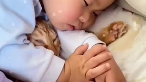 Cute baby and cat sleeping on bed