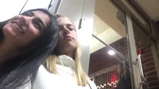Girl falls over asleep while friend is taking selfie white sweater