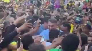 In Brazil, Bolsonaro trying to get through the crowd to get to the meeting