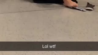 Girl in black sweater typing on phone with feet on floor