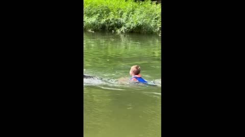 Horse pulls kid through water by his tail short