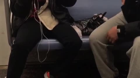 Two sisters argue with each other on the subway