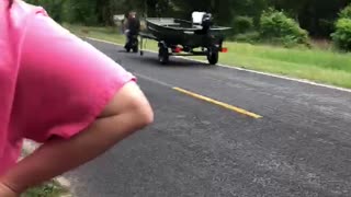 Man Tows Boat on Mini Bike