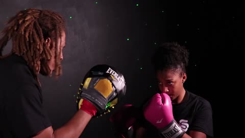 A Man Training A Woman In Boxing