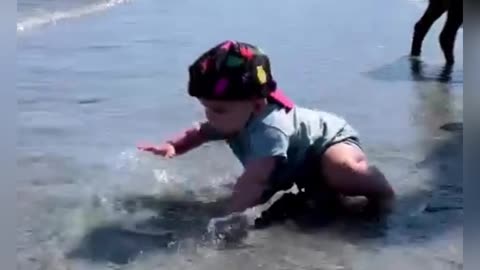 cute baby playing in the water please follow me