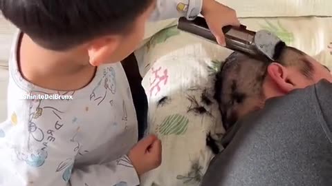 little boy playing barber