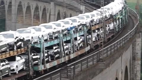 A long Audi train pulled by a Siemens Smartron