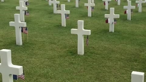 American and French flags wave by headstones on 79th anniversary of D-Day in Normandy