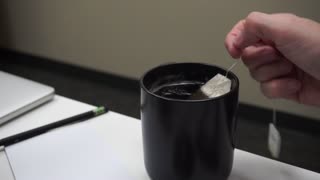 Teabag being dipped in a cup of tea
