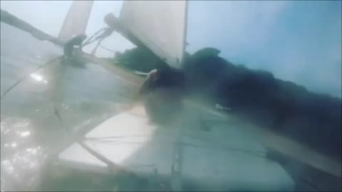 Guy Gets Shoved off Board by Sail While Windsurfing