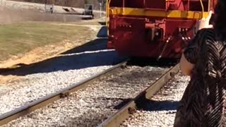 Vintage Train Arrives At Station With Excited Onlookers.