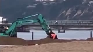 Digger scoops up driver stuck in sea