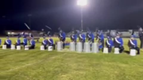 Childerburg High School drum line preforming on buckets and garage cans