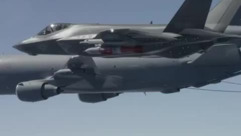 In the air, an F-15C flies near a second plane.