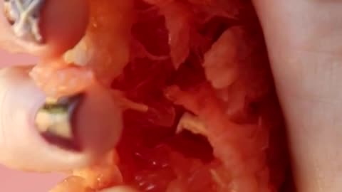 disorderly vertical video squeezing grapefruit