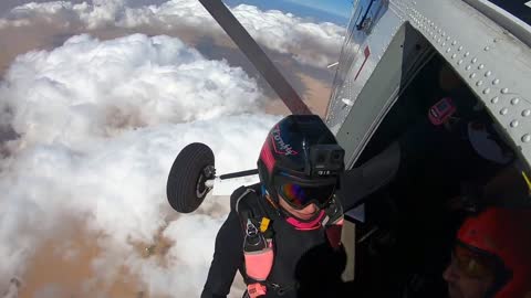 Skydiver Does Backflips As She Flies Between The Clouds