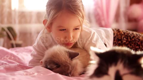 Girl playing with cat