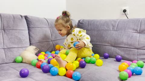 Baby and Kitten Play With Colorful Balls