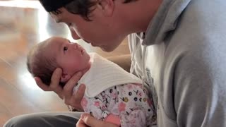 Infant Lifts Head for Nose Kisses