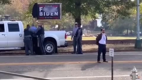Man ARRESTED after trying to COVER UP "F*ck Joe Biden" sign