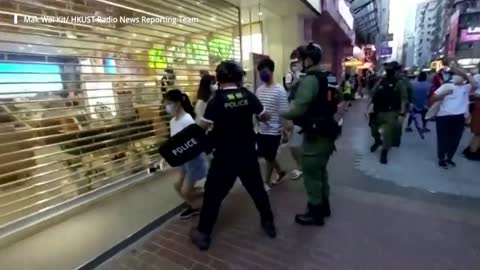Hong Kong police officer tackles and pins 12-year-old girl to ground during anti-government rally