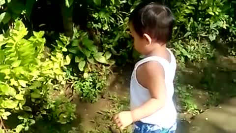 Toddler attempts to befriend his own shadow