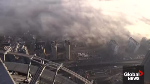 Wall of fog rolls across Toronto from Lake Ontario, creating an eerie scene