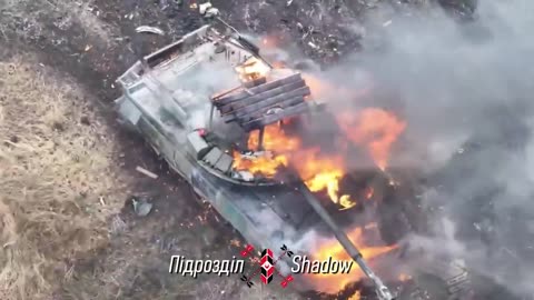 Ukrainian Shadow drone unit dropping an US M67 grenade through the open hatch of a Russian tank