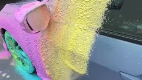 Spray colored foam on the car before washing it