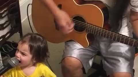 Toddler sings with grandad