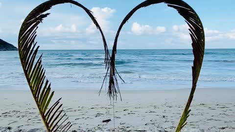 A Heart Shaped Made From Palm Leaves For Photo Shots in sea beach feeling great