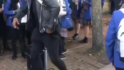 Rapper plays "don't take the vaccine" song outside a school with a speaker