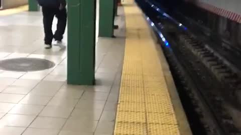 Construction workers chase mouse and kick it into subway train tracks