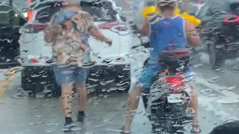 Older Lady Gives Motorcyclist Rain Coat During Storm