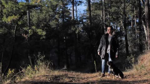 Man in the woods with his dog