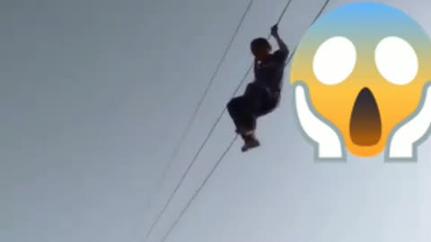 People Hanging on high voltage cables