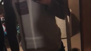 Man in grey shirt films self falls into mirror