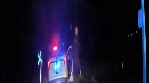 Colorado police officer leaving a handcuffed woman in police car which is struck by train