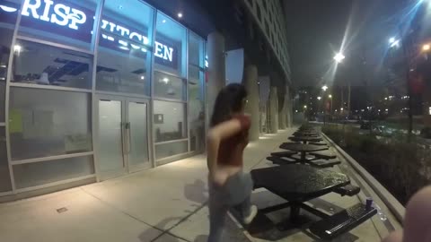 Girl dances with friends, climbs up on outside table, slips, and falls off