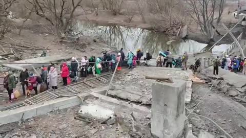 Ukraine Residents in the suburb of Irpin leave their embattled town over remains of their bridge