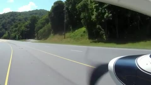 Pilot lands plane in the middle of a highway as people continue driving