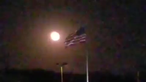 Old glory flying with the man on the moon