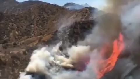 Firefighters using helicopters to control/put down the fire