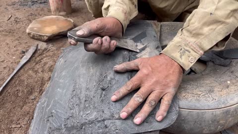 Hard working Old Man Repairing Big Tractor Tire Using Aluminium Mold