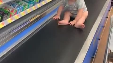 Baby Rides Grocery Conveyer Belt _ ViralHog