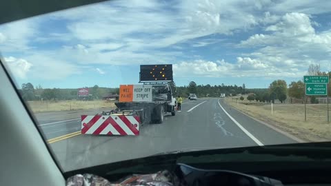 Highway crews directing traffic into on coming traffic