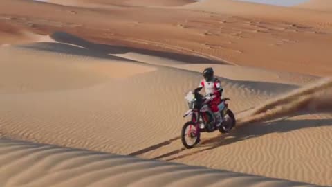 Riding a motorbike over sand dunes