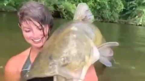 girl dives and catches catfish only with her hands