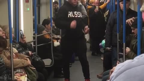 Guy black sweater jacket dancing subway train