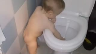Funny baby doing the cleaning